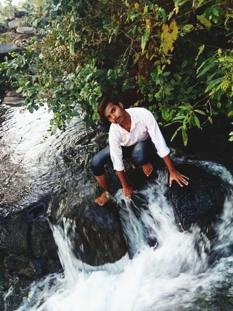 water, motion, nature, one person, full length, real people, waterfall, day, plant, lifestyles, leisure activity, flowing water, waterfront, outdoors, beauty in nature, young adult, long exposure, scenics - nature, flowing