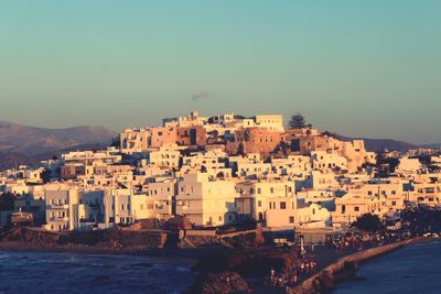 Townscape by sea against clear sky