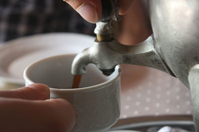 Cropped hand holding coffee