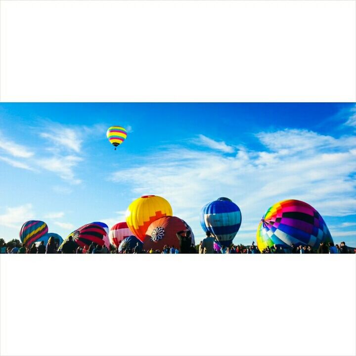 multi colored, sky, blue, colorful, in a row, balloon, cloud - sky, leisure activity, umbrella, cloud, beach umbrella, variation, side by side, yellow, outdoors, sport, beach, day, hot air balloon