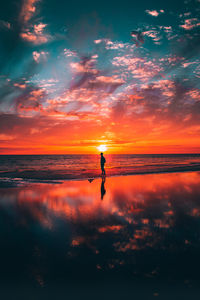 Silhouette man at beach against sky during sunset