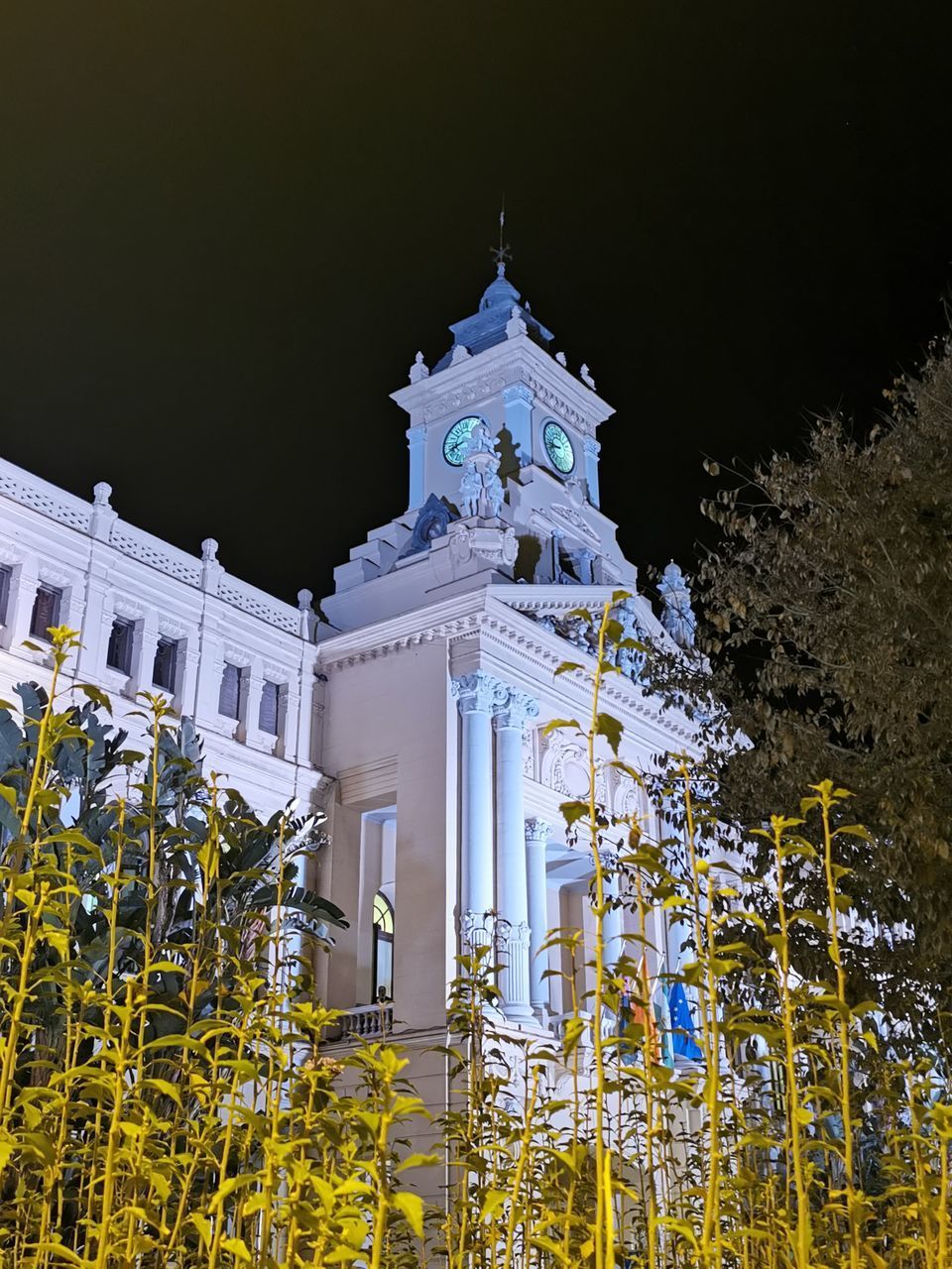 LOW ANGLE VIEW OF LIT BUILDING AGAINST SKY