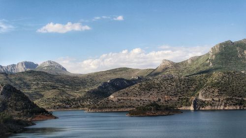 Scenic view of lake and mountains against sky