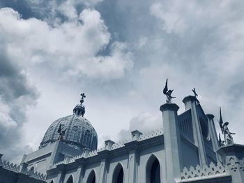 Low angle view of building against cloudy sky