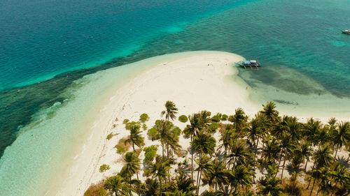 Sandy beach and tropical island by atoll with coral reef. patongong island with sandy beach