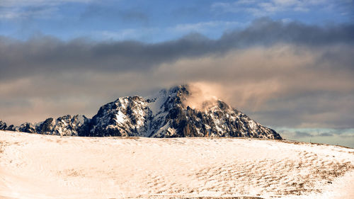 Scenic view of snowcapped mountain against sky