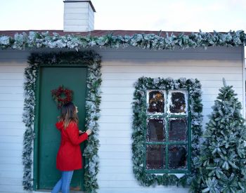 Woman standing at doorway with christmas