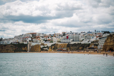 Town by sea against sky in city