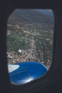 Aerial view of cityscape seen through airplane window