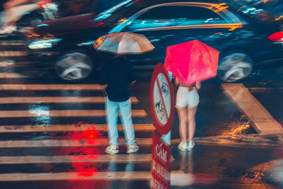 Rear view of woman walking on street