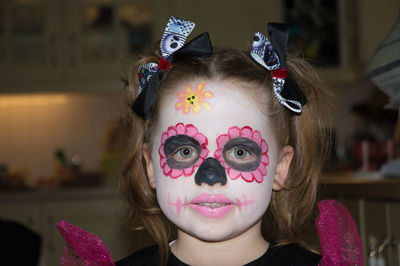 Close-up portrait of girl with painted face during halloween