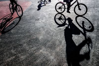 Low section of people riding bicycles on road