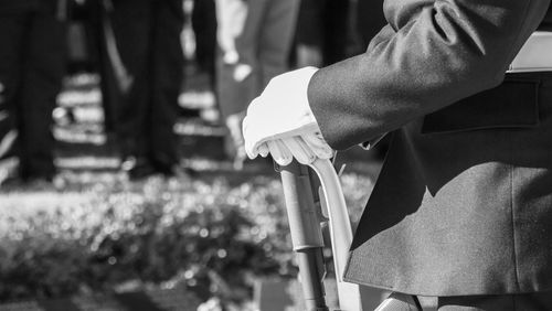 Midsection of person standing at memorial