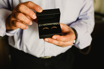 Close-up of man holding rings