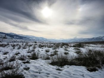 Scenic view of mountains against cloudy sky