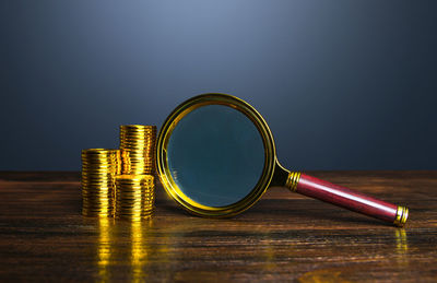 Close-up of magnifying glass on table