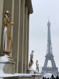 Statue of liberty against sky in city