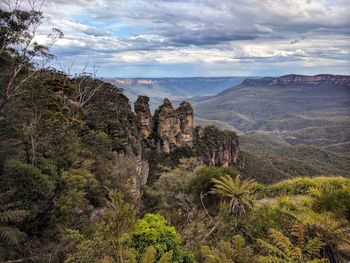 Scenic view of mountains against cloudy sky