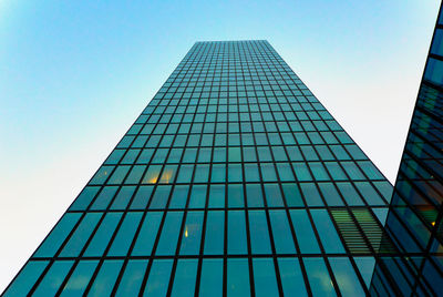 Low angle view of modern building against clear blue sky