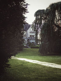 Lawn by building against clear sky