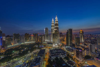 High angle view of city lit up at night