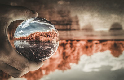 Close-up of hand holding crystal ball