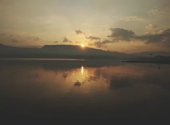 Scenic view of lake against sky during sunset