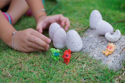 Midsection of boy holding toy on field