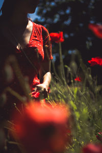 Midsection of young woman wearing red dress