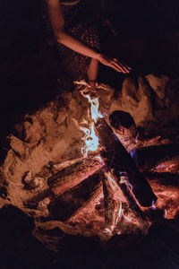 High angle view of woman standing by bonfire