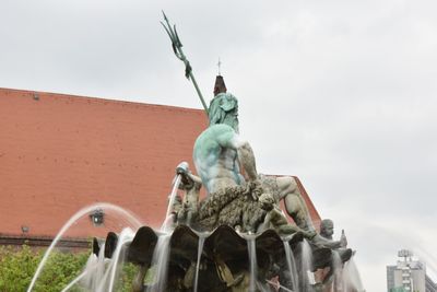 Low angle view of statue against sky