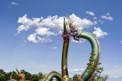 Low angle view of sculpture against blue sky