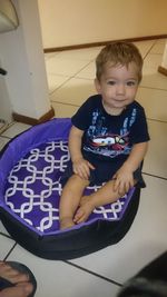 High angle view of girl sitting on floor