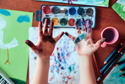 High angle view of woman hand against graffiti