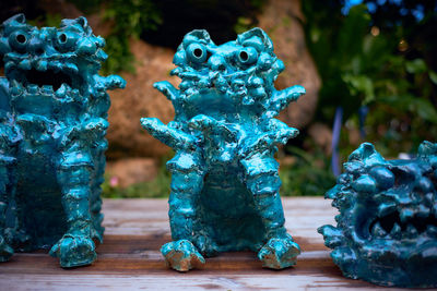 Turquoise statues on table