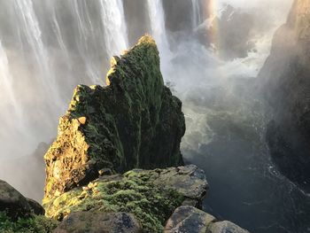 Scenic view of waterfall against sky