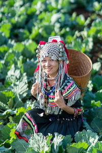 High angle portrait of woman in traditional clothing amidst farm