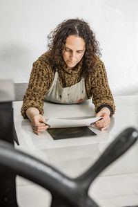 Female artist getting a plate ready for printing using a manual