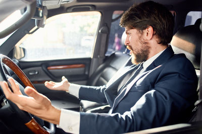 Man sitting in car