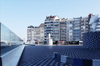 Buildings against clear blue sky in city