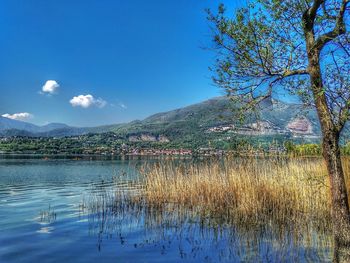 Scenic view of lake against blue sky