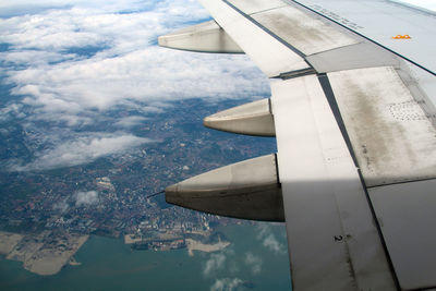 Aerial view of aircraft wing against sky