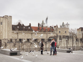People on historical building in city