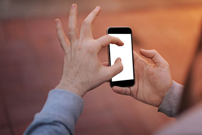 Midsection of man using mobile phone