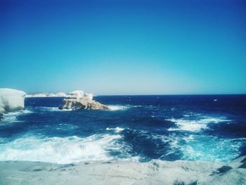 Scenic view of sea against clear blue sky