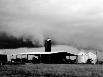 View of rural landscape against cloudy sky