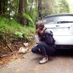 Full length of woman sitting in car