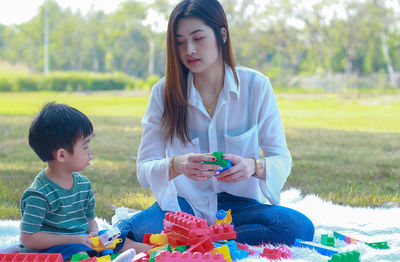 Mother playing with son at park