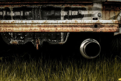 Close-up of rusty car on grass