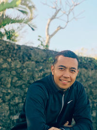 Portrait of smiling man against trees